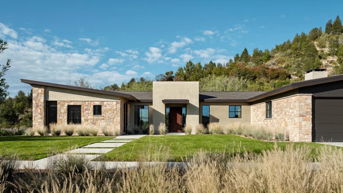 Modern single-family Texas Hill Country rental house in stone and stucco with a covered front entry and a low xeriscaped yard, the kind of San Antonio area property where the lease, not a statute, decides when a landlord may enter