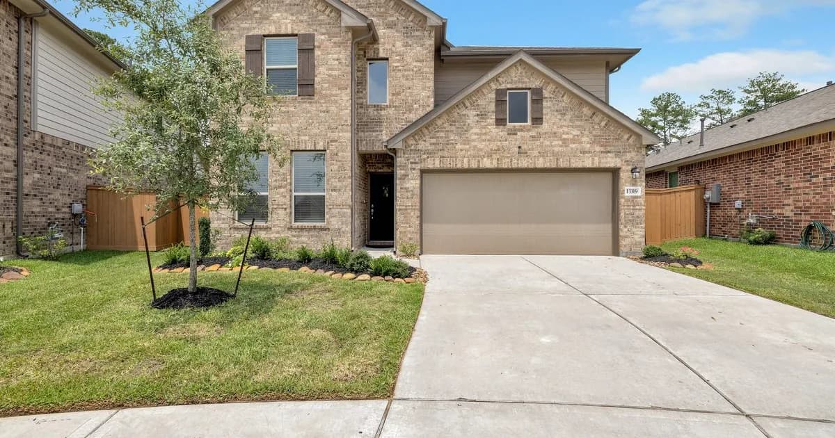 Newer two-story brick Houston master-planned community rental home with manicured landscaping and tan garage — Cinco Ranch, Sienna, The Woodlands, Bridgeland HOA rental rules landlord guide