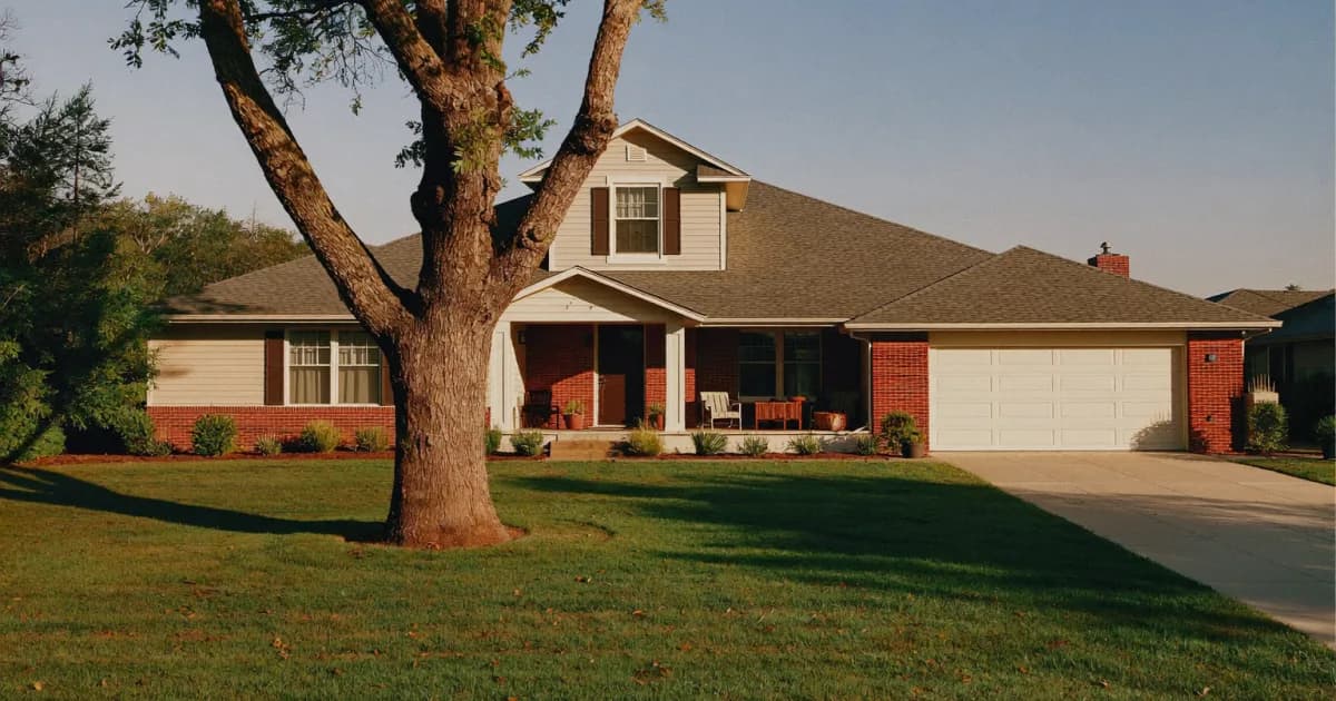 Brick and siding single-family rental home with a front porch, mature shade tree, green lawn and two-car garage in a Houston-area suburb at golden hour, the kind of property where Texas landlord rights apply