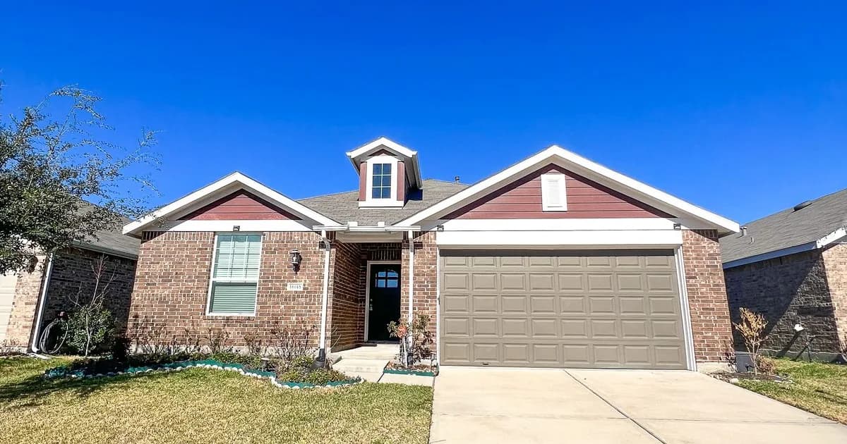 Newer single-story brick Houston rental home with red trim and two-car garage — Texas Property Code §92.056 bold-and-underlined lease typography compliance landlord guide